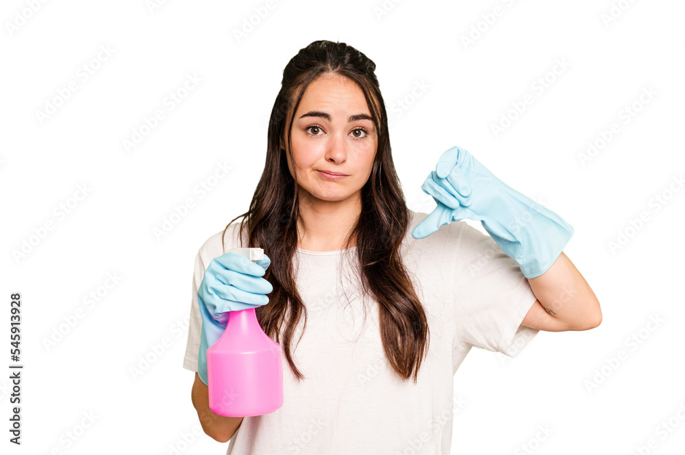Young cleaner caucasian woman isolated on green chroma background showing a dislike gesture, thumbs down. Disagreement concept. Young cleaner caucasian woman isolated on green chroma background showing a dislike gesture, thumbs down. Disagreement concept.