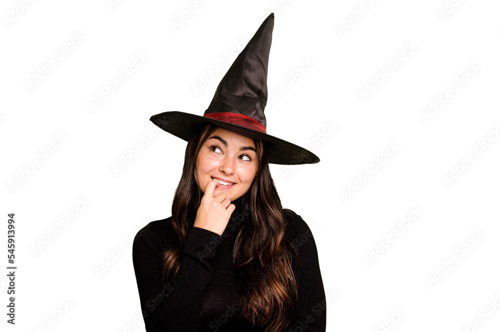 Young caucasian woman dressed as a witch isolated on green chroma background relaxed thinking about something looking at a copy space. Young caucasian woman dressed as a witch isolated on green chroma background relaxed thinking about something looking at a copy space.