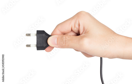 closeup hand holding electrical plug and power socket