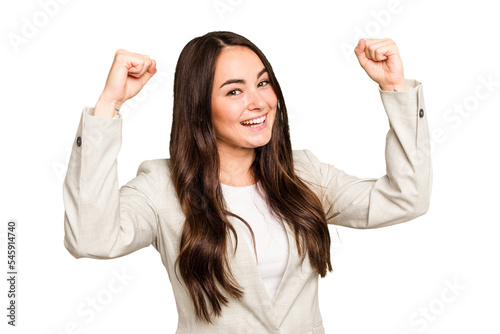 Young caucasian woman isolated on green chroma background cheering carefree and excited. Victory concept.