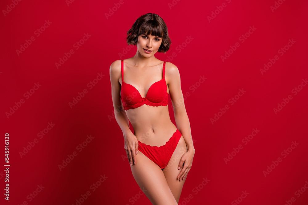 Portrait of attractive feminine fit slim girl posing wearing lingerie isolated over bright red color background Portrait of attractive feminine fit slim girl posing wearing lingerie isolated over bright red color background