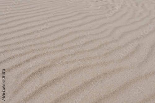 Abstract minimal hot summer vacation texture. Closeup view of beach or desert dune sand waves. Aesthetic neutral colour nature landscape