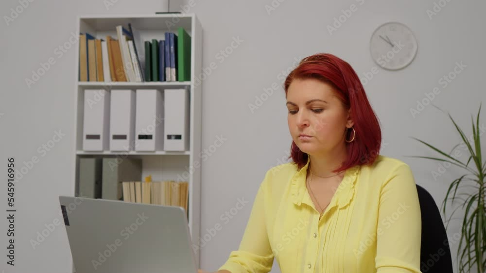 Medium shot of entrepreneur using laptop writing notes at home office desk tired of working. Business woman professional work on computer planning agenda with personal planner and online calendar. Medium shot of entrepreneur using laptop writing notes at home office desk tired of working. Business woman professional work on computer planning agenda with personal planner and online calendar.