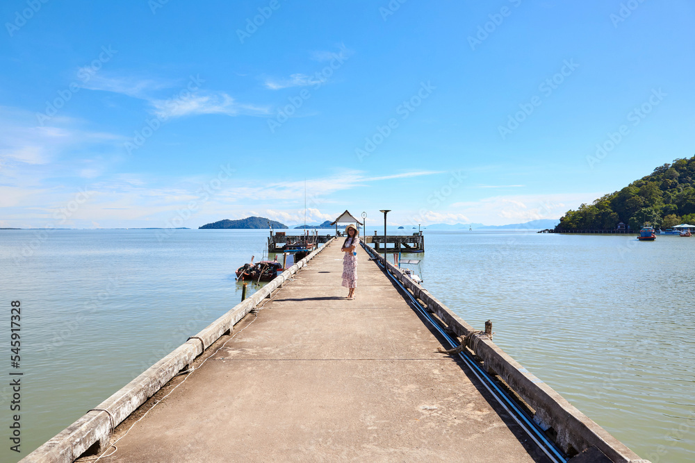 Fototapeta premium A woman standing on cement pier