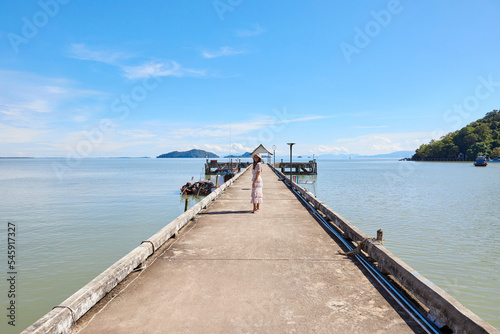 A woman standing on cement pier