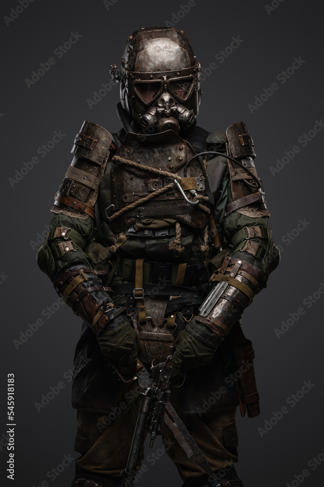 Shot of isolated on grey background soldier in setting of post apocalypse looking at camera.