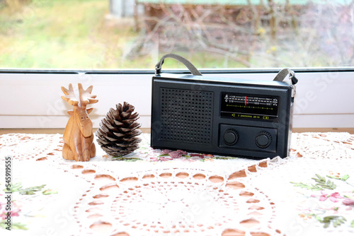 wooden elk, a cone and an old soviet radiogram on a knitted napkin
