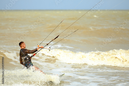 Young Man KiteBoarding on the waves Extreme Sport Kitesurfing