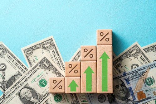 Wooden blocks with interest rate percent of bank with US dollars, financial world economy crisis design concept.