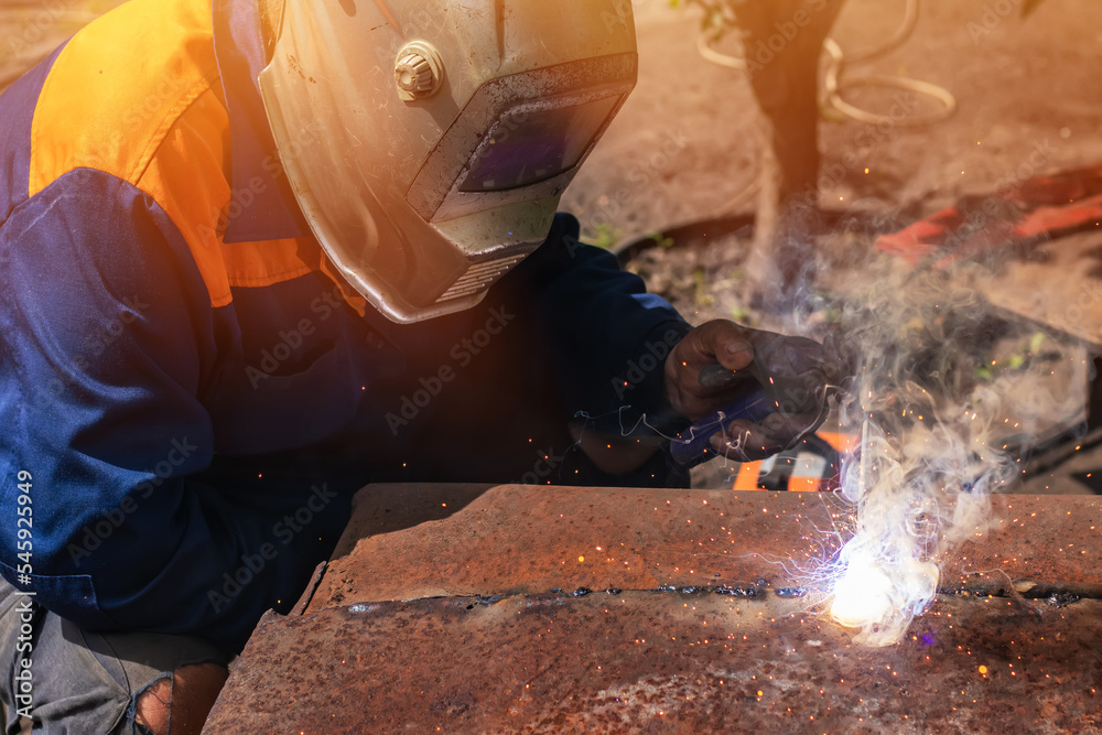 Worker wearing industrial uniforms and Welded Mask industrial safety first concept. Worker wearing industrial uniforms and Welded Mask industrial safety first concept.