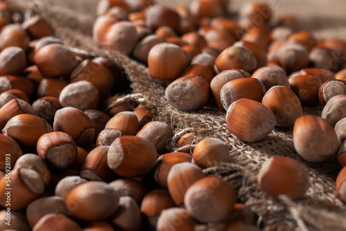 close up of hazelnuts on wooden table, top view