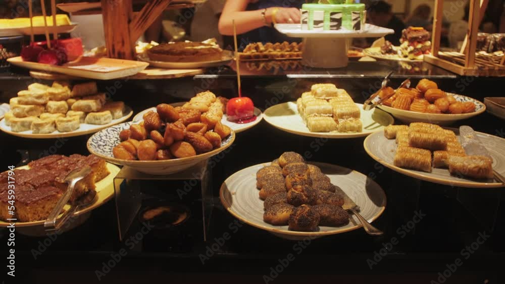 Traditional Turkish dessert close up. Various desserts in plates on display at counter in hotel, closeup of fresh sweet food during buffet at restaurant.