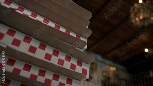 Close-up - pizza boxes stacked on top of each other in a restaurant