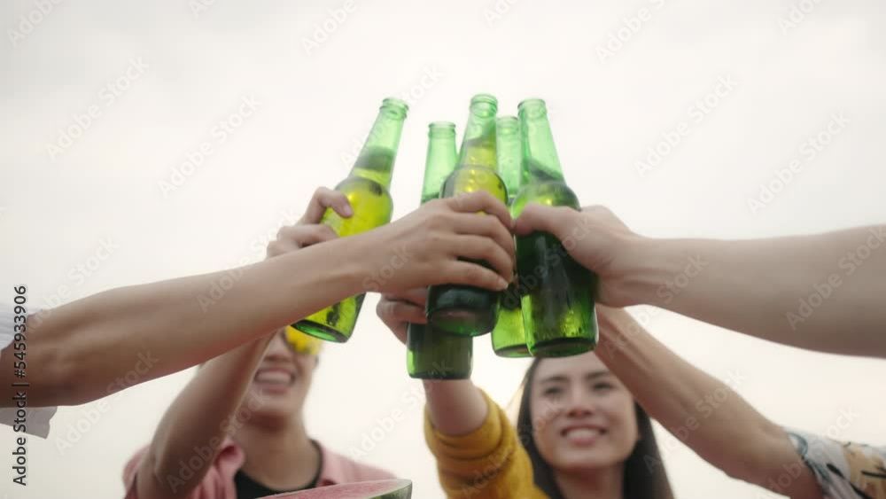 Celebration beer cheers concept,Beautiful people toasting with drinks at summer,hands holding up bottles of beer of people group in outdoor party vacation.Smiling men and women enjoying time together Celebration beer cheers concept,Beautiful people toasting with drinks at summer,hands holding up bottles of beer of people group in outdoor party vacation.Smiling men and women enjoying time together