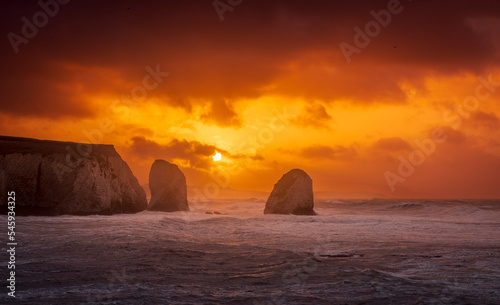 Stormy November sunrise at Freshwater Bay and Stag rock Isle of Wight south east England