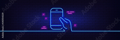 Neon light glow effect. Hold Smartphone icon. Give Cellphone or Phone sign. Ð¡ommunication Mobile device symbol. 3d line neon glow icon. Brick wall banner. Hold Smartphone outline. Vector