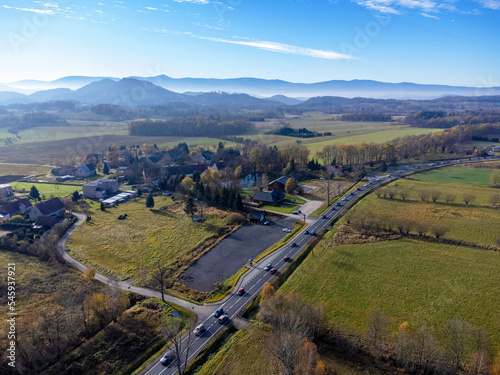 Obraz na płótnie Aerial view of charming small town in Poland. Mountains with fall multicolor trees and beaufitul sky. w salonie