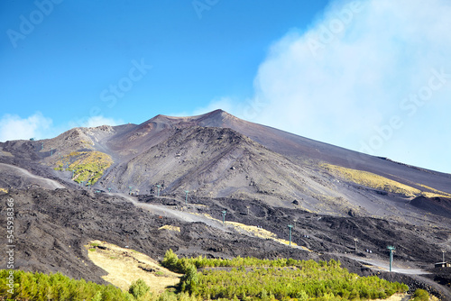 Volcano Etna, Sicily, Italy. Slopes with road and cableway. Crater of Etna. Smoking peak of active volcano Etna.