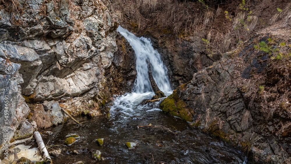 A mountain river flowing over rocks in spring A mountain river flowing over rocks in spring