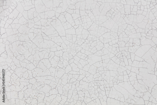 Cracked ceramic texture. Cracked white ceramic background. photo
