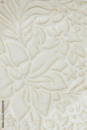 Close up detail of a white plate with print of flowers