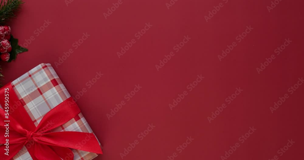 Background with gift box with red bow and spruce branch and place for text. Looped 4K stop motion animation Background with gift box with red bow and spruce branch and place for text. Looped 4K stop motion animation