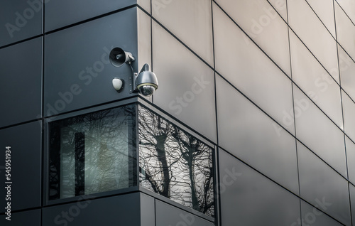 Security camera or CCTV is outsite on the wall of the modern building. Video equipment for safety system area control outdoor, The concept of Professional surveillance, Selective focus. photo