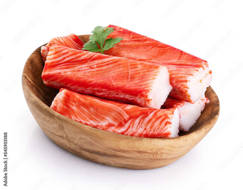 Crab sticks and parsley in a wooden bowl isolated on white background. With clipping path.