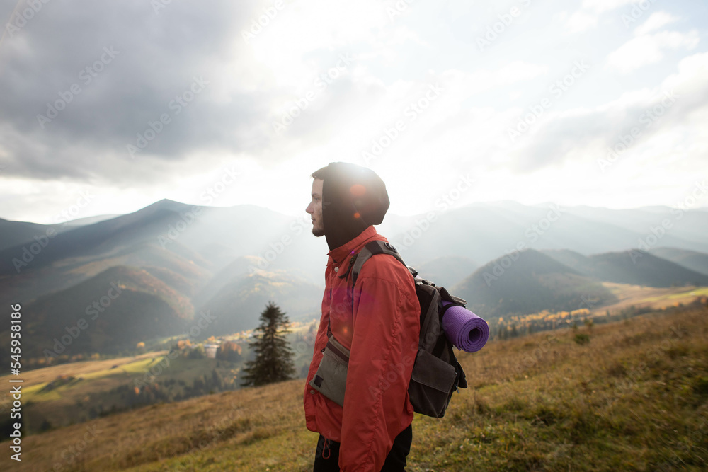 freedom, a young man stands on top of a mountain