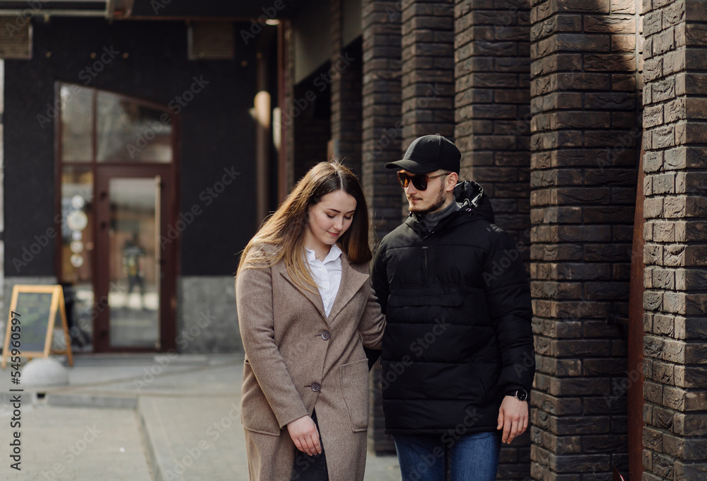 Young couple posing near wall