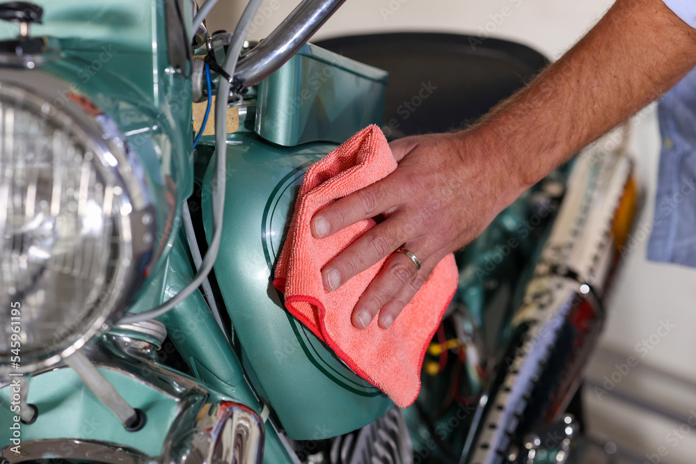 The man washing and cleaning motorbike. Man doing color polishing holds the soft microfiber cloth applying nano coating on a metal steal polishing his classic motorcycle to get more shiny color.
The man washing and cleaning motorbike. Man doing color polishing holds the soft microfiber cloth applying nano coating on a metal steal polishing his classic motorcycle to get more shiny color.