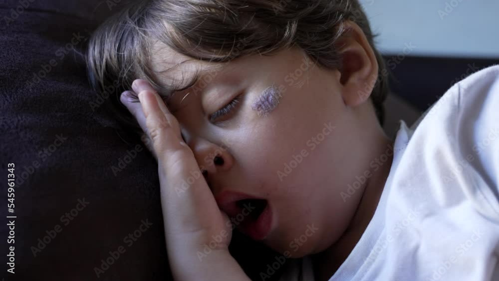 Adorable child asleep during afternoon nap. Closeup face of tired small boy sleeping. Yawning kid resting while napping Adorable child asleep during afternoon nap. Closeup face of tired small boy sleeping. Yawning kid resting while napping