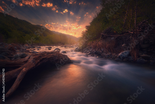 Magical sunrise over fast flowing mountain river