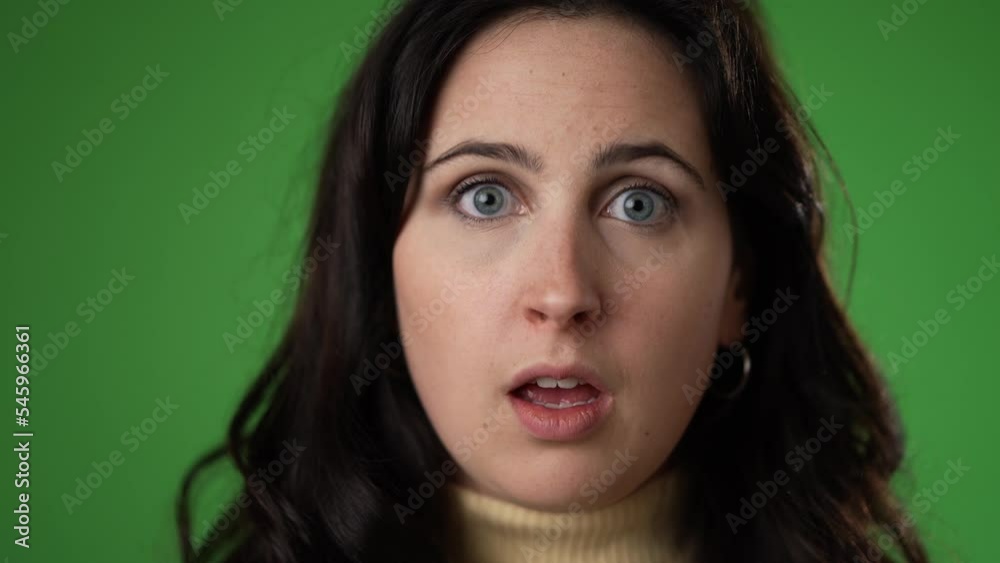 Slow motion closeup portrait of excited young woman 20s anticipate great success, winner, WOW, isolated on green screen background. Slow motion closeup portrait of excited young woman 20s anticipate great success, winner, WOW, isolated on green screen background.
