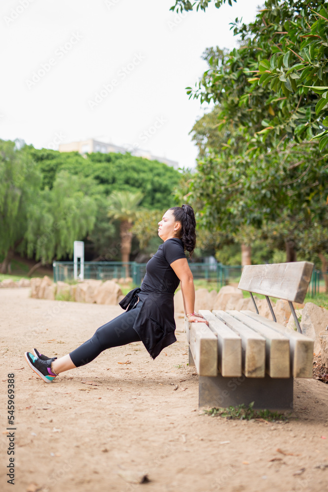 Fototapeta premium Pretty fat woman doing outdoor exercises