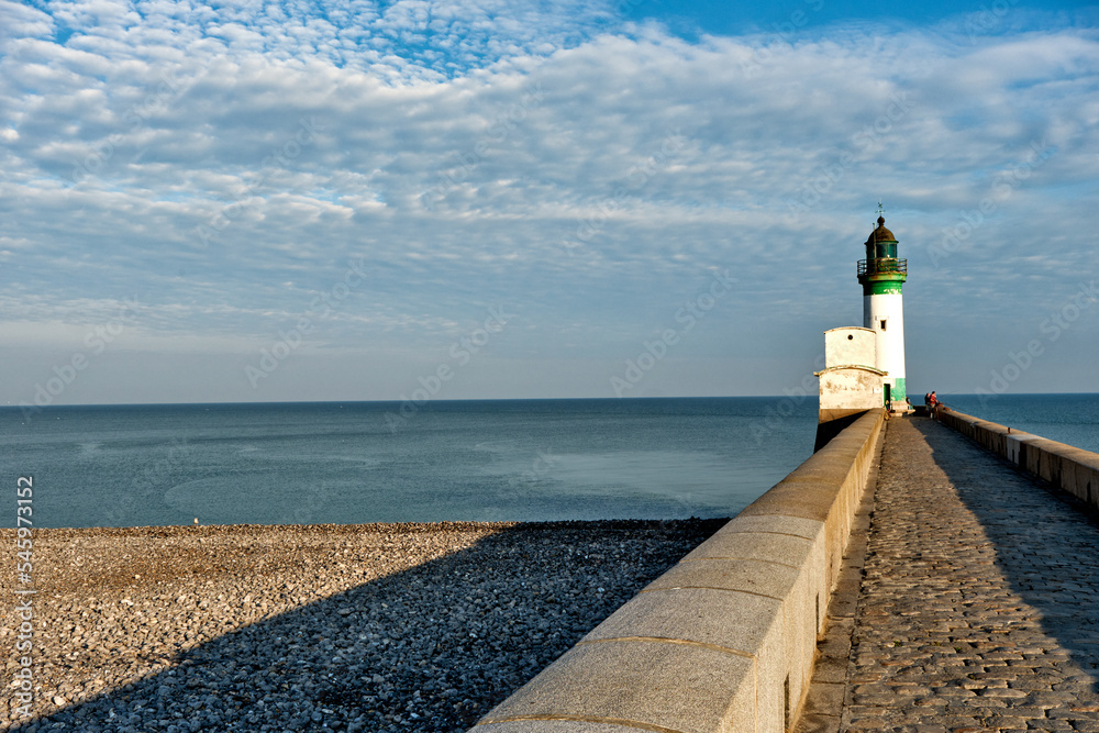the pebble beach, lighthouse and pier at Le Treport, Seine-Maritime department in Normandy, France.