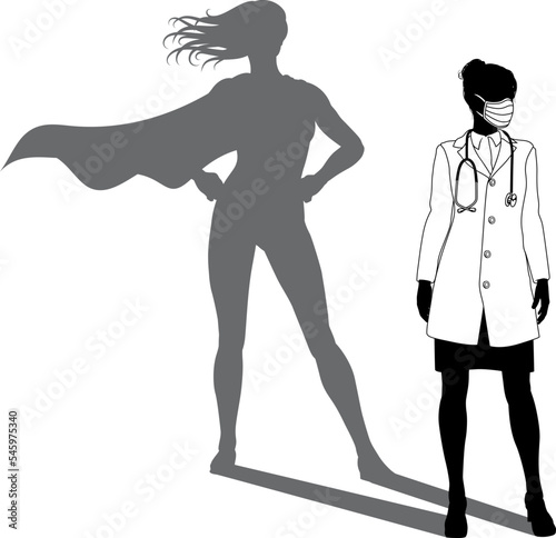 A superhero medical doctor woman health care worker revealed by her shadow silhouette as a super hero in a cape.