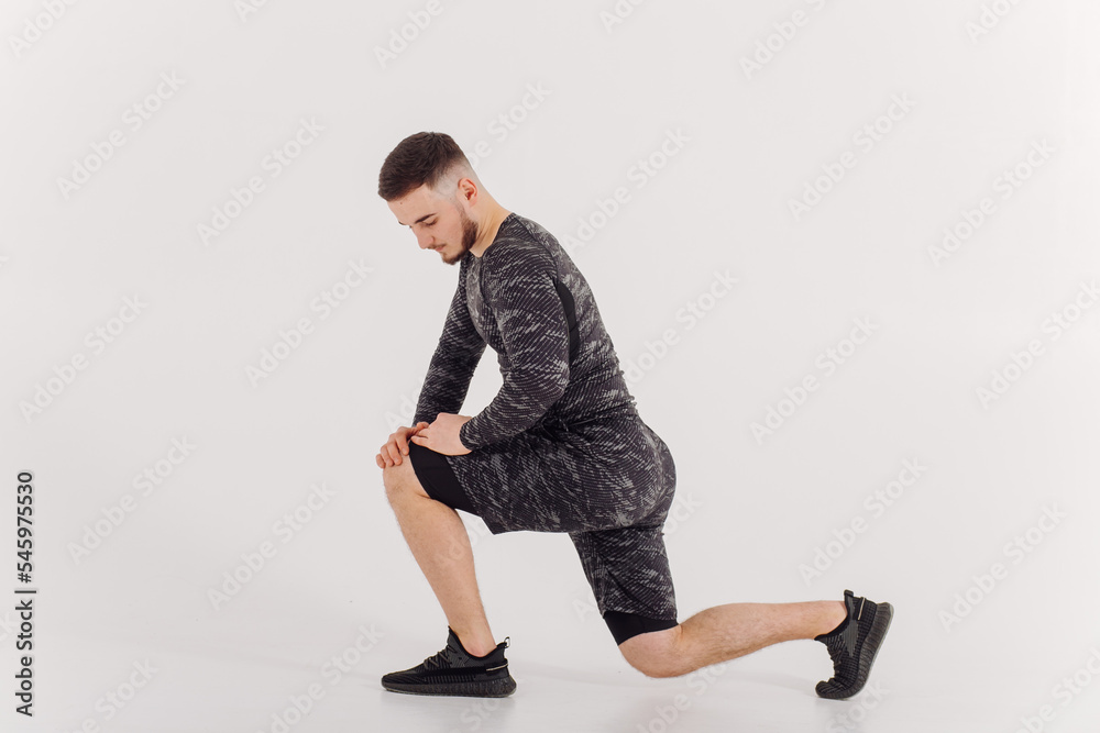 Athletic young man doing workouts at home, man doing training, warm up before weight exercise. Athletic young man doing workouts at home, man doing training, warm up before weight exercise.