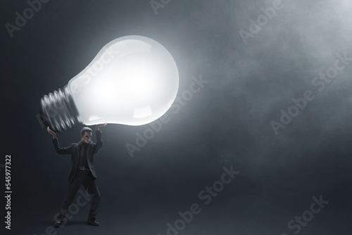 Business man lifting lamp 3d illustration photo