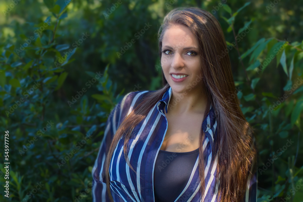 young woman outside green vegetation happy girl smiling pretty natural at the park