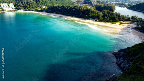 Aerial view of beautiful tropical beach of Nai Harn on Phuket island  Thailand. Sunny morning light.