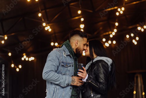 Outdoor happy couple in love posing near cafe