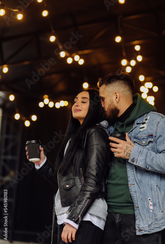 Outdoor happy couple in love posing near cafe