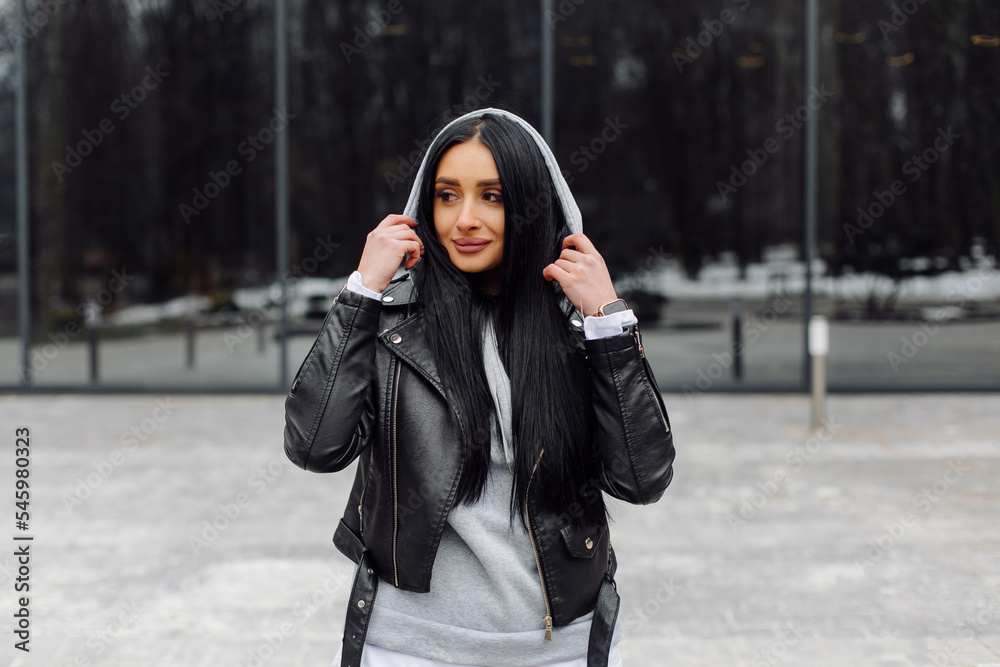 Young caucasian girl with dark long hair in sporty gray hoodie Young caucasian girl with dark long hair in sporty gray hoodie