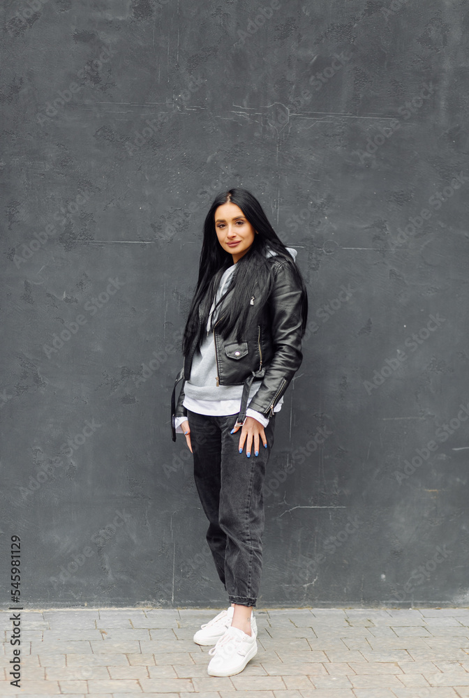 Young caucasian girl with dark long hair in sporty gray hoodie Young caucasian girl with dark long hair in sporty gray hoodie