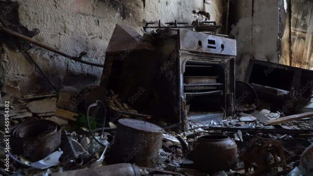 Bombed kitchen and things close-up. Consequences fire after a russian shellings. Left belongings of residents. Fire in the house. 