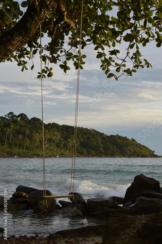 Vertical shot of a play swing on the tropical beach photo