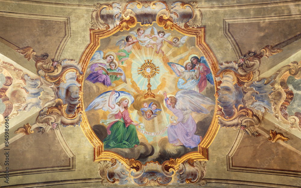 VARALLO, ITALY - JULY 17, 2022: The baroque ceiling fresco of Eucharistic adoration of angels in the church Collegiata di San Gaudenzio by Carlo Bartolomeo Borsetti (1702).