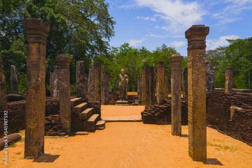 Pillars and standing Buddha in Polonnaruwa Sacred Quadrangle photo