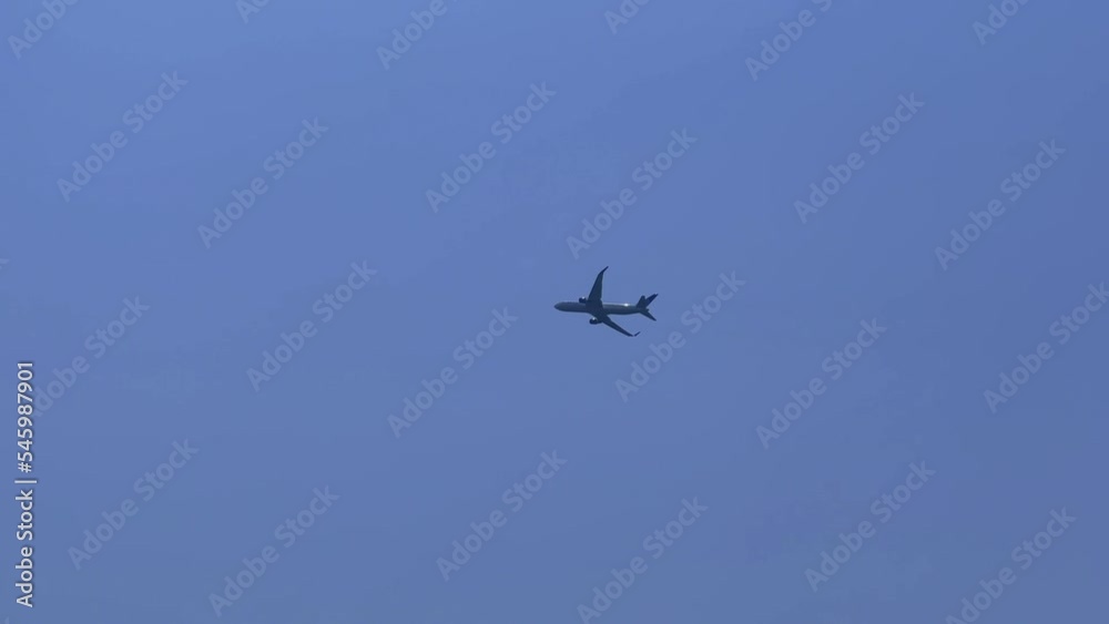 Low-angle shot of an airplane against a blue sky Low-angle shot of an airplane against a blue sky